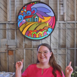 2-Portia-Po-Chapman-Love-Art-by-Po-Kingston-Artist-Posing-with-Base31-Mural-Building-a-Bright-Future